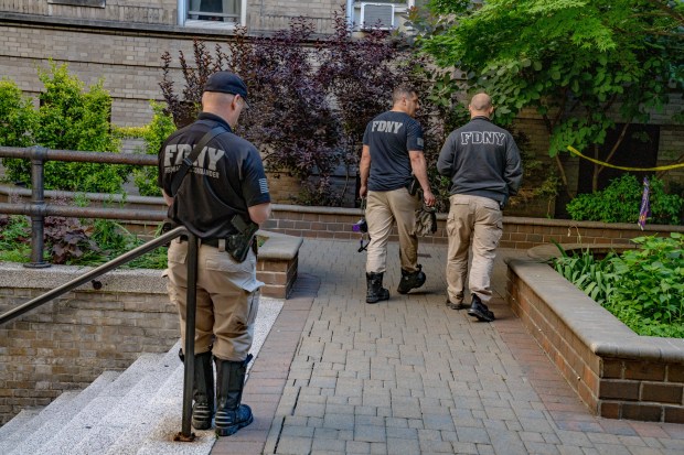 FDNY Fire Marshals investigate a fatal fire in a Sunnyside apartment building on Monday morning.
