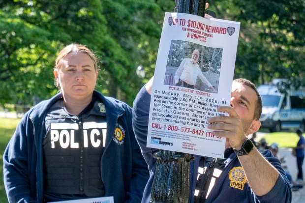 Police post flyers inside Kissena Park on Thursday seeking information on the death of Albert Itzkowitz.
