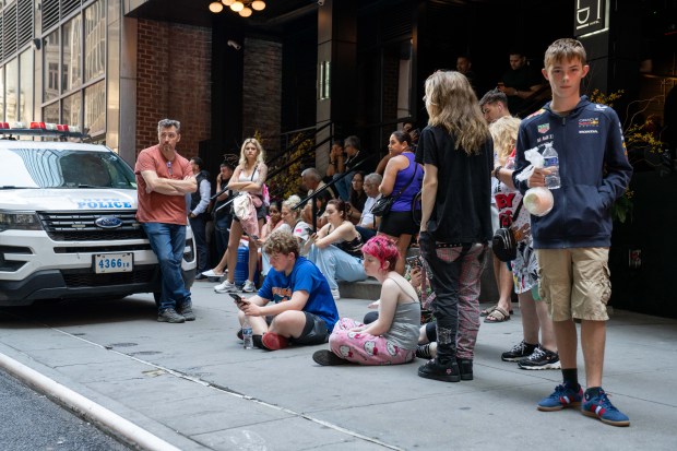 Guests are evacuated after a woman released bear spray inside the Hilton Double Tree Hotel in lower Manhattan on Monday.