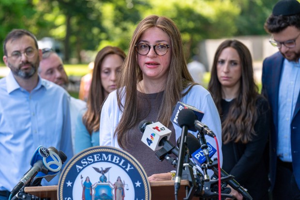 Albert Itzkowitz's daughter Leah Livshitz speaks at a press conference in Kissena Park on Thursday. 