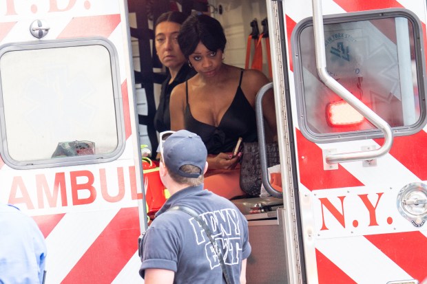 A woman is treated by medics after being exposed to bear spray inside the Hilton Double Tree Hotel in lower Manhattan on Monday. 