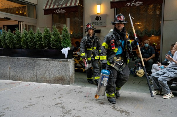 Guests are evacuated after a woman released bear spray inside the Hilton Double Tree Hotel in lower Manhattan on Monday.