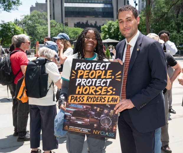 A supporter of Ryder's Law poses with New York City Councilman Christopher Marte outside New York's City Hall Wednesday, June 10, 2026 in Manhattan, New York. (Barry Williams/ New York Daily News)