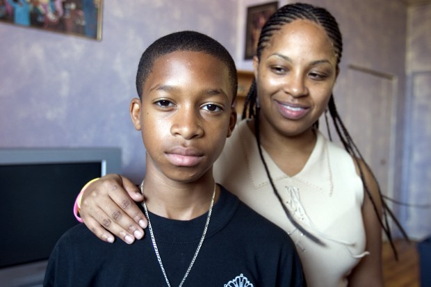 Thomas Little, 13, and his mother, Josephine De Jesus, are pictured at their home in Brooklyn in 2005. (Michael Scott Berman for New York Daily News)