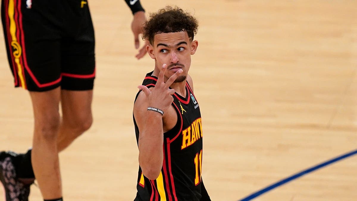 Trae Young gestures during NBA playoff game