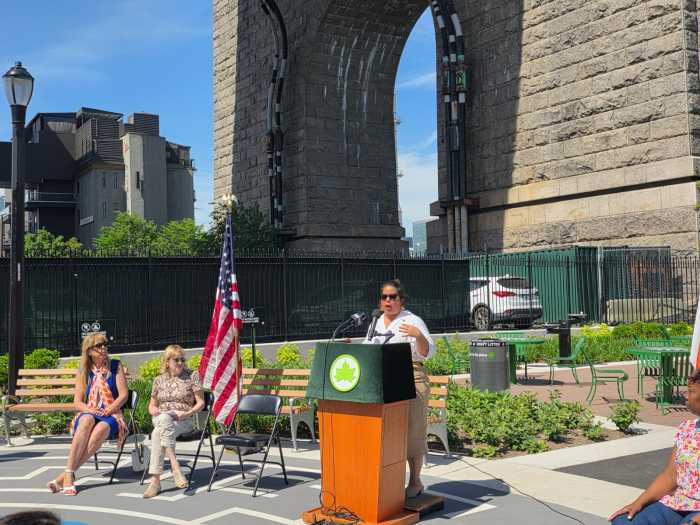 NYC Parks Commissioner Tricia Shimamura speaks ahead of the ribbon cutting at Queensbridge Baby Park. Photo by Shane O'Brien.