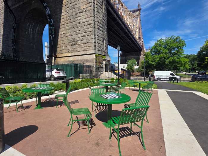 Queensbridge Baby Park features multiple chess tables framed by the Queensboro Bridge. Photo by Shane O'Brien.