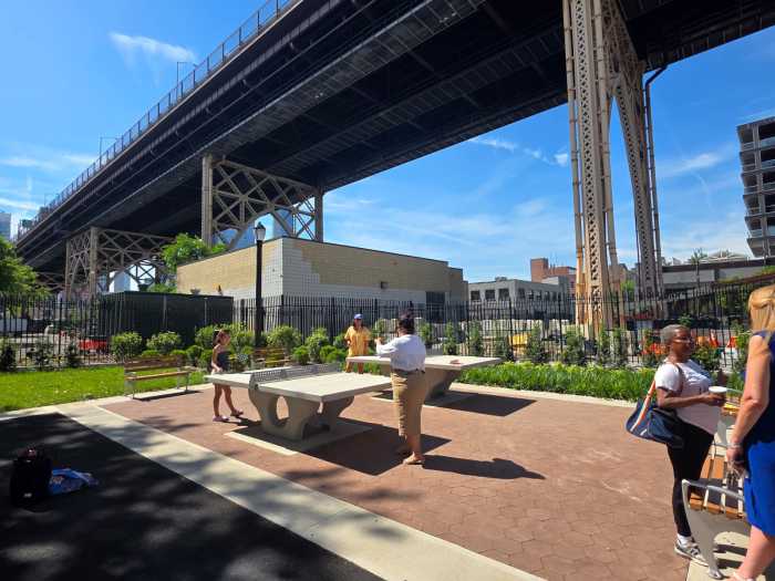 NYC Parks Commissioner Tricia Shimamura tries out one of the park's new ping pong tables. Photo by Shane O'Brien.