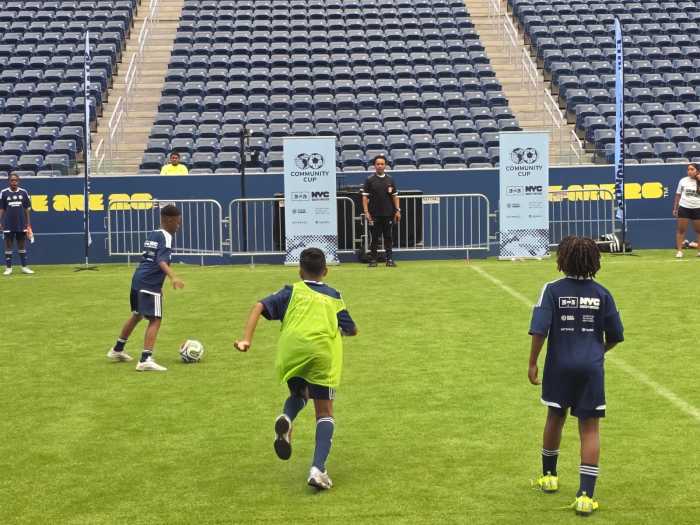 Teams from St. George and Crown Heights take part in the 2026 Community Cup final at Louis Armstrong Stadium. Photo by Shane O'Brien.