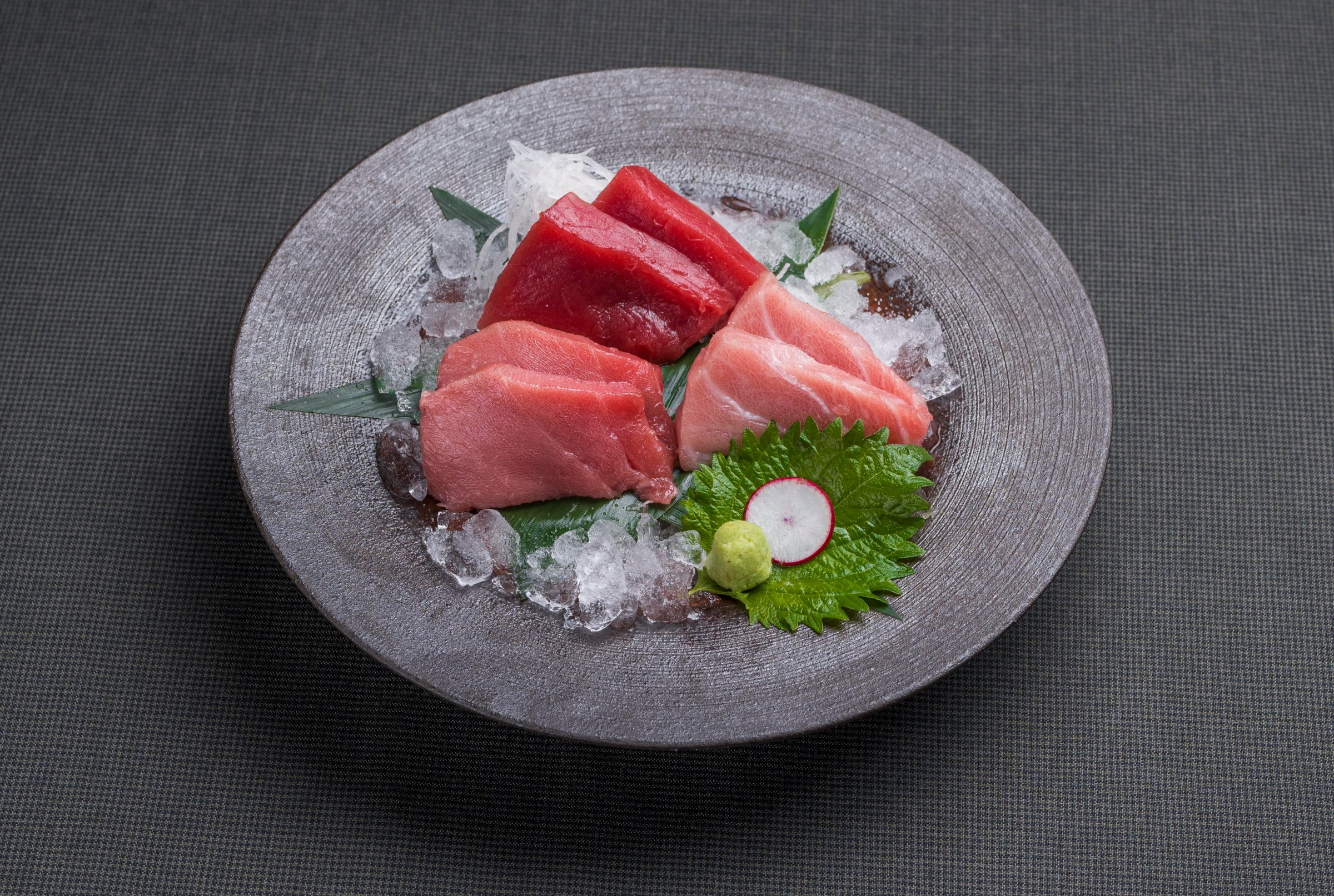 A plate of sliced red meat fish.
