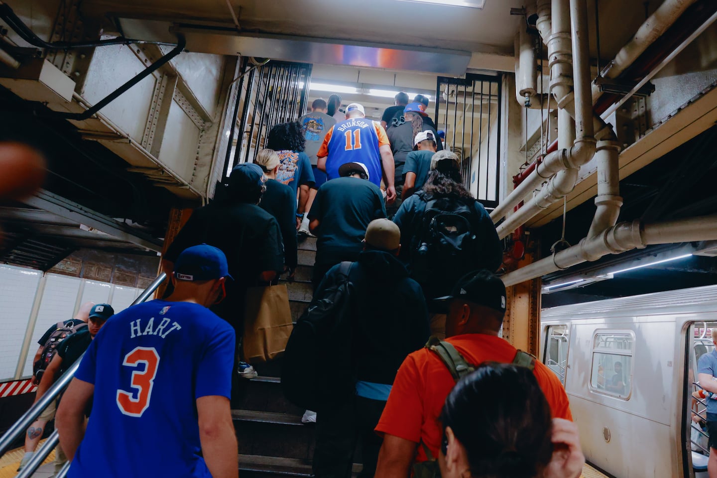 New York Knicks fans pass through Union Square station on their way to a parade for the NBA champions in Lower Manhattan on Thursday.