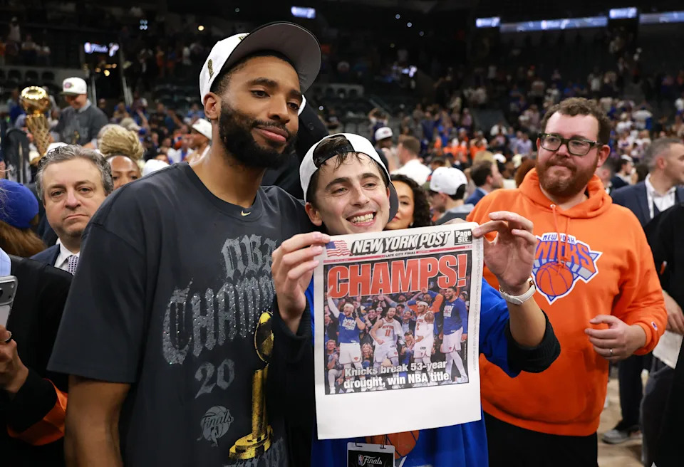 Timothée Chalamet celebrates with Mikal Bridges #25 of the New York Knicks.