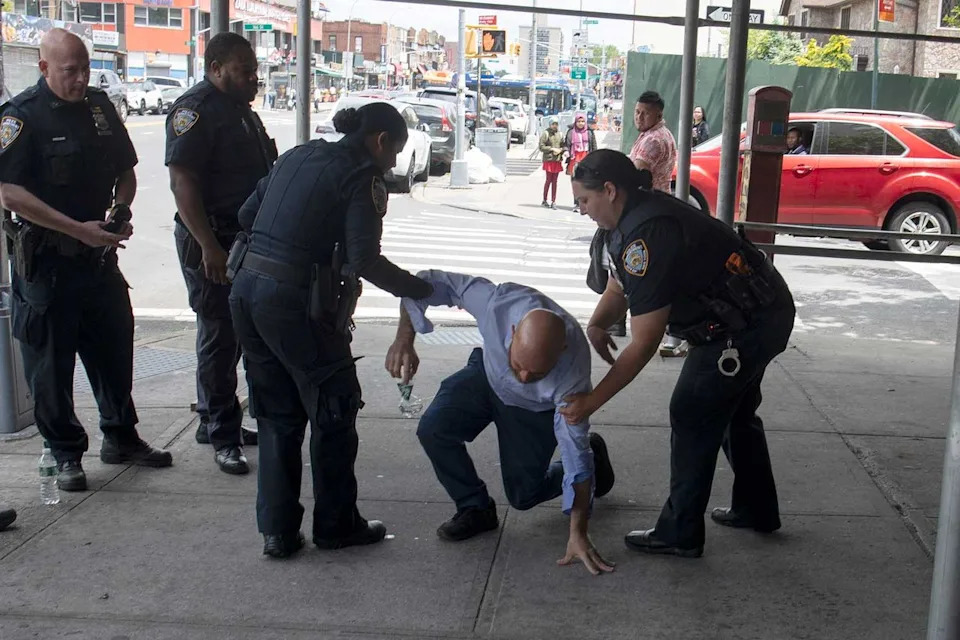 Jonathan Rinaldi, a right-wing activist, tries to recover after being pepper sprayed just before he was to lead a small demonstration to protest a hotel housing migrants on June 4, 2023, in Queens, N.Y.Credit: Andrew Lichtenstein/Corbis via Getty