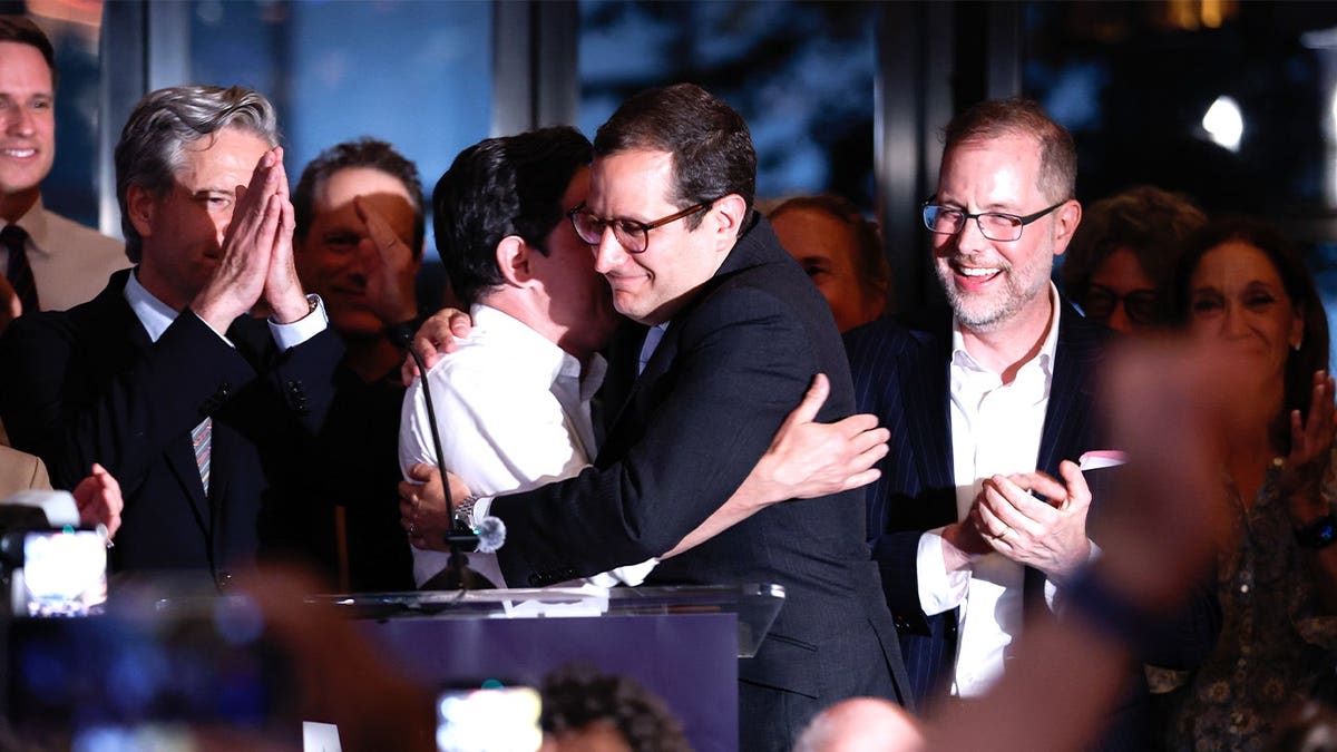 man hugging supporters during watch party