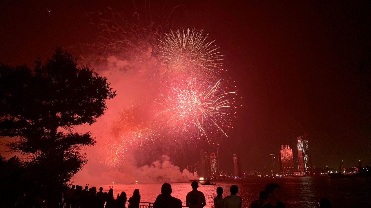 People watch the Macy's 4th of July Fireworks show along the East River, late Sunday, July 4, 2021, in New York.