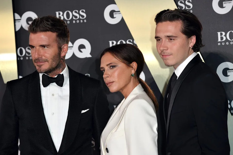 Brooklyn Beckham pictured with his parents in 2019 (Getty Images)
