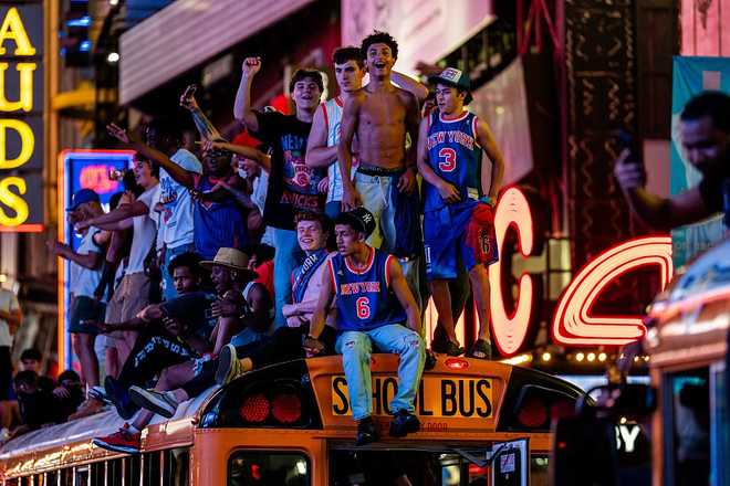 Knicks Fans Gather In NYC To Watch Game 5 Of The NBA Finals Against The San Antonio Spurs NEW YORK, NEW YORK - JUNE 14: New York Knicks fans climb on buses as they celebrate after they win the NBA Finals in Times Square on June 14, 2026 in New York City. The New York Knicks lead the San Antonio Spurs 3-1 and could win the franchise's first NBA championship since 1973 if they win tonight.(Photo by Adam Gray/Getty Images)