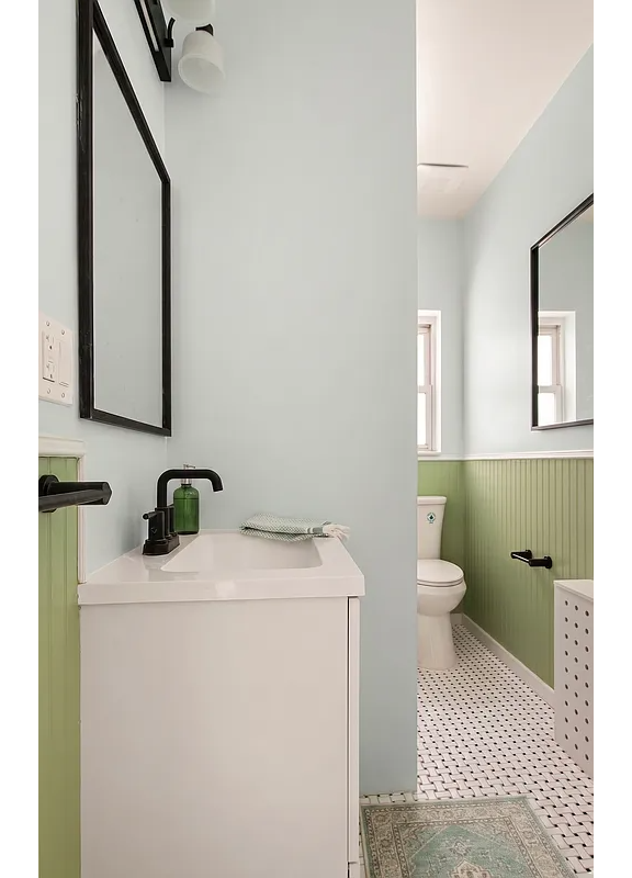 bathroom with green painted wainscoting