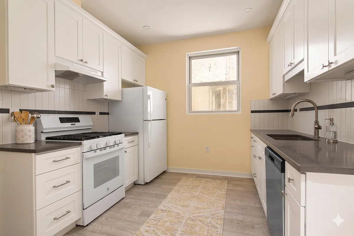 windowed kitchen with white cabinets