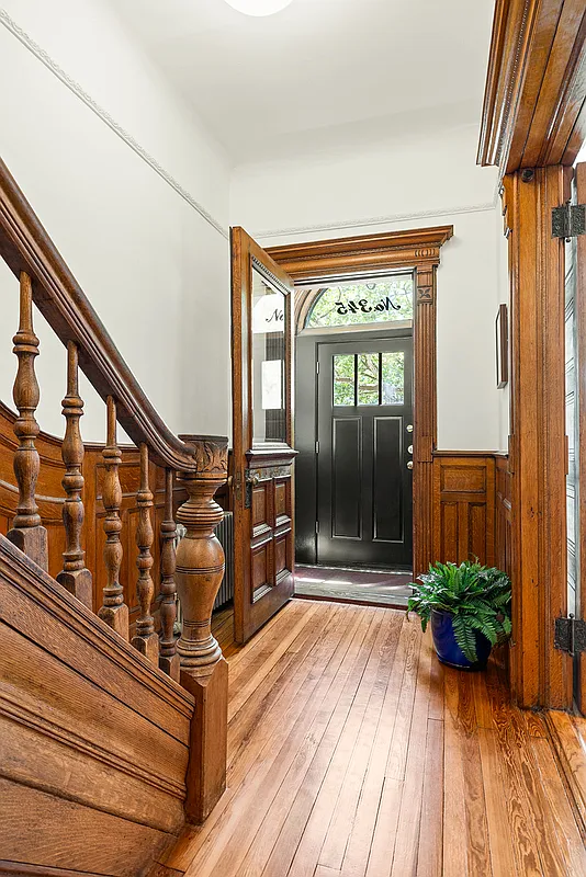 entry with wainscoting, stair,