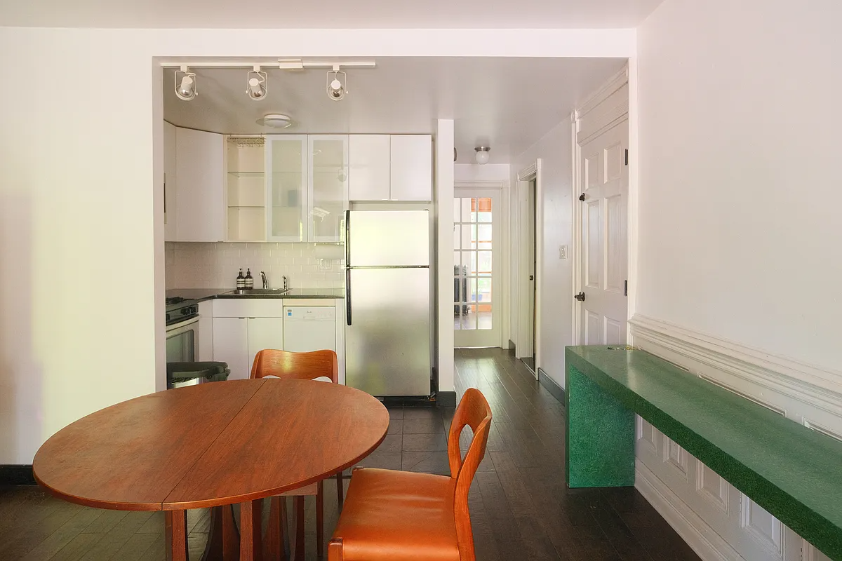 living room with view into kitchen with white cabinets