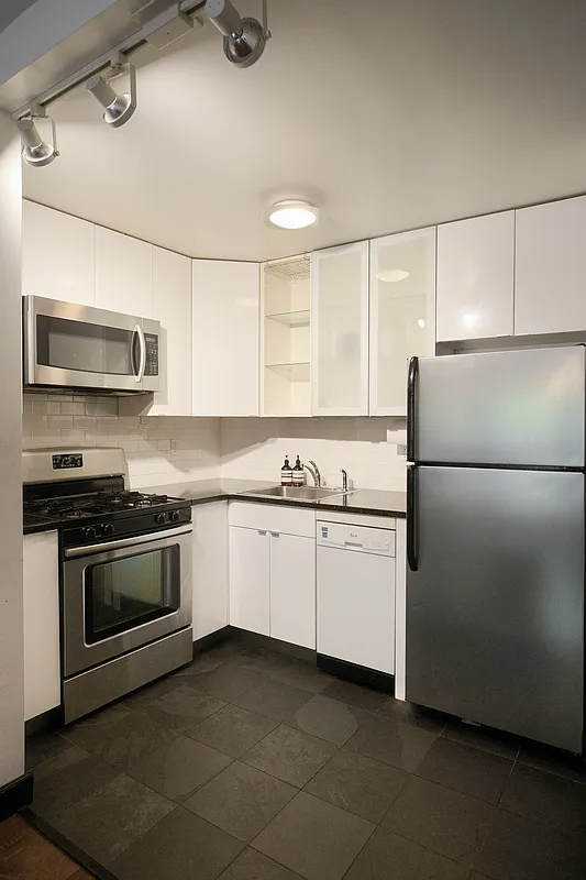 kitchen with white cabinets, a dishwasher