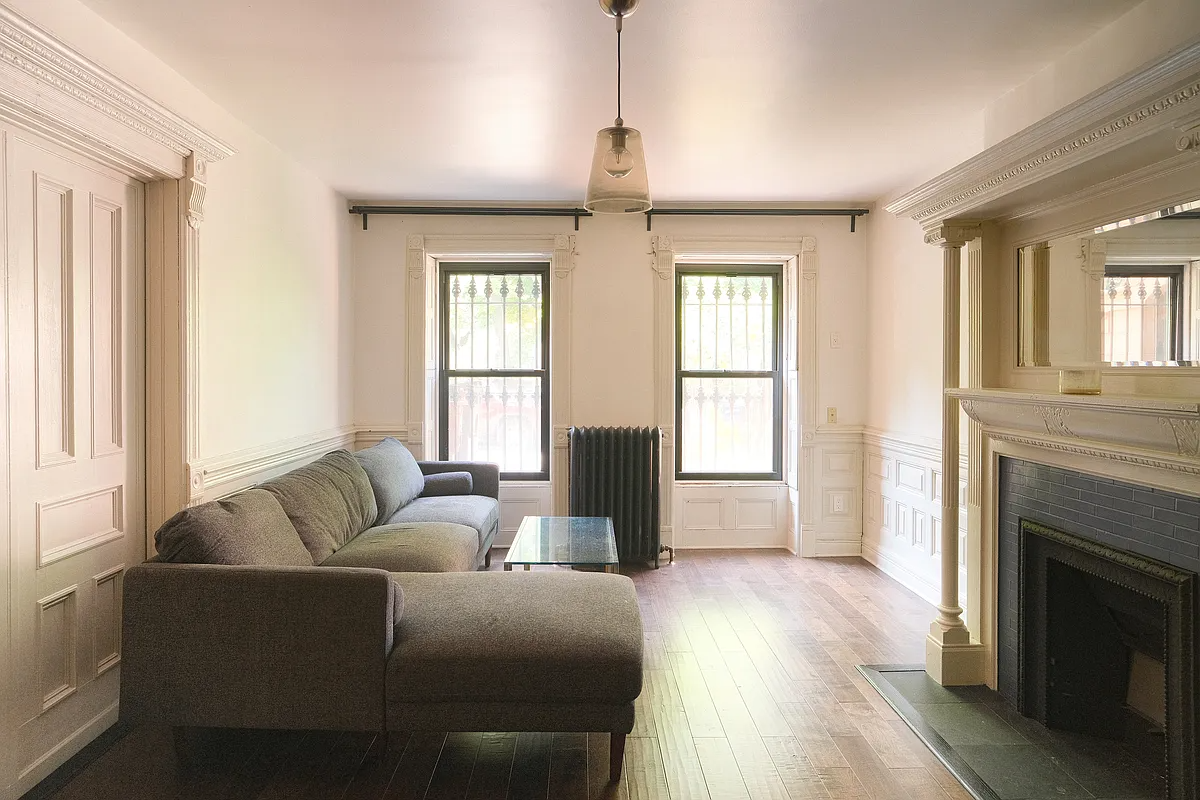 living room with two windows, wainscoting, mantel