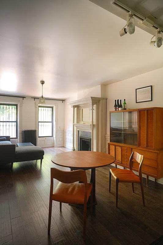 living room with two windows, wainscoting, mantel