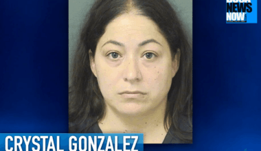 Mugshot of a woman with long dark hair and a neutral expression, set against a gray background.