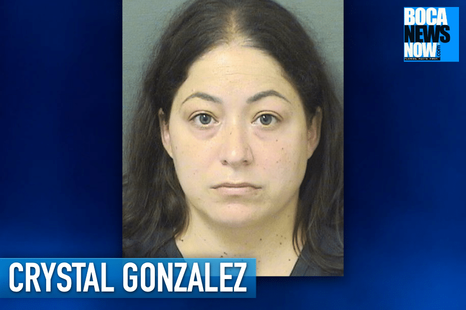 Mugshot of a woman with long dark hair and a neutral expression, set against a gray background.