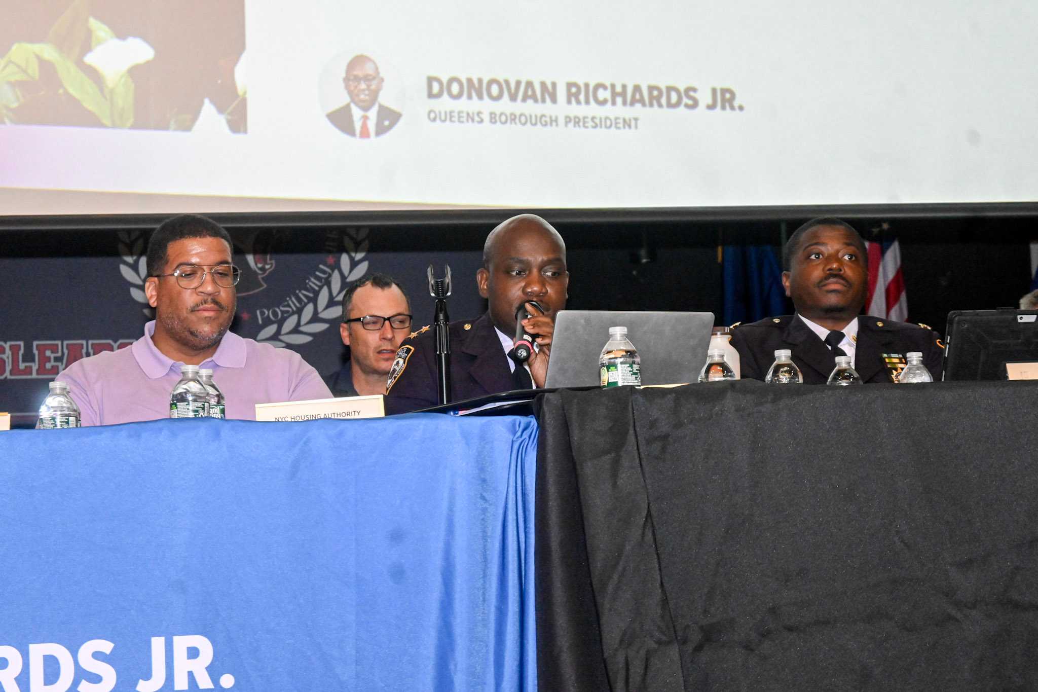 An NYPD official speaks during the town hall.