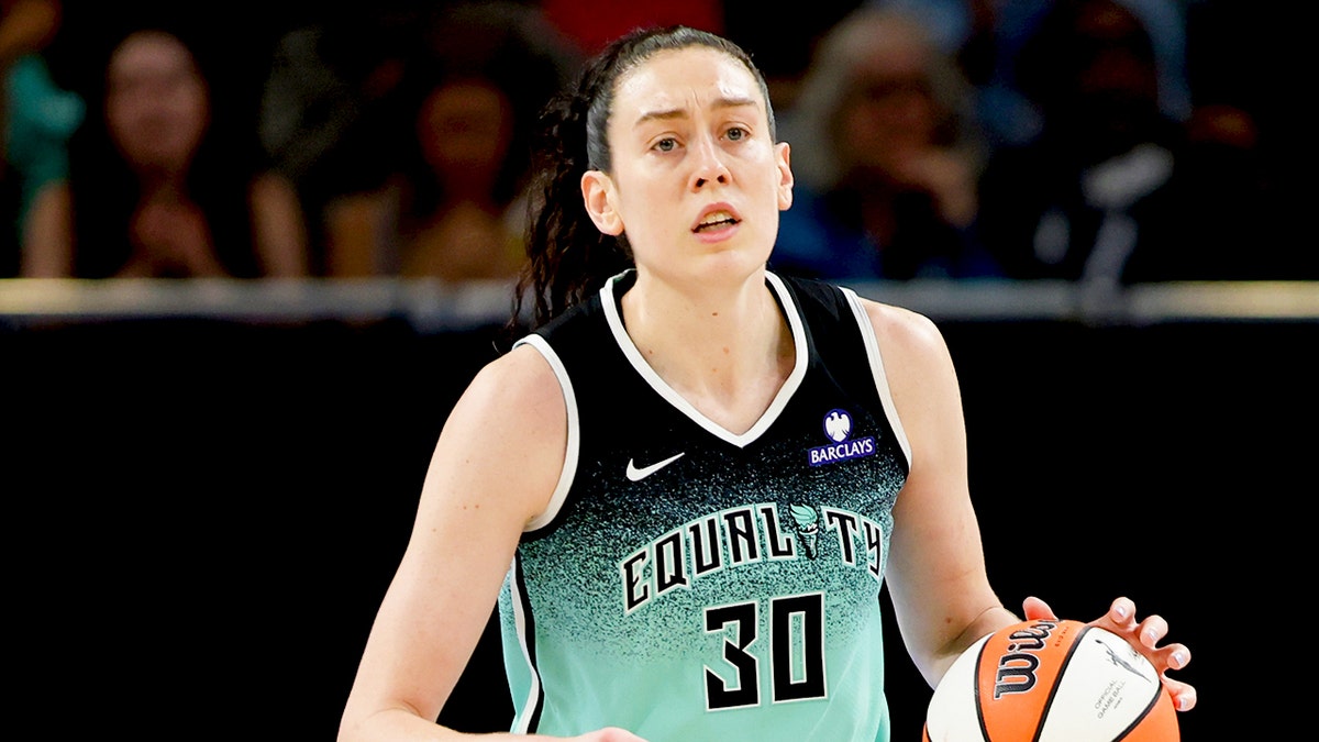 Breanna Stewart dribbling basketball on court during game