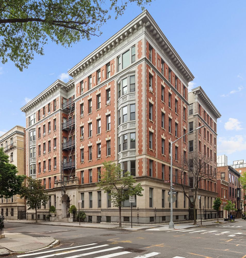 brick building with windowed bays, quoining, and keystoned lintels