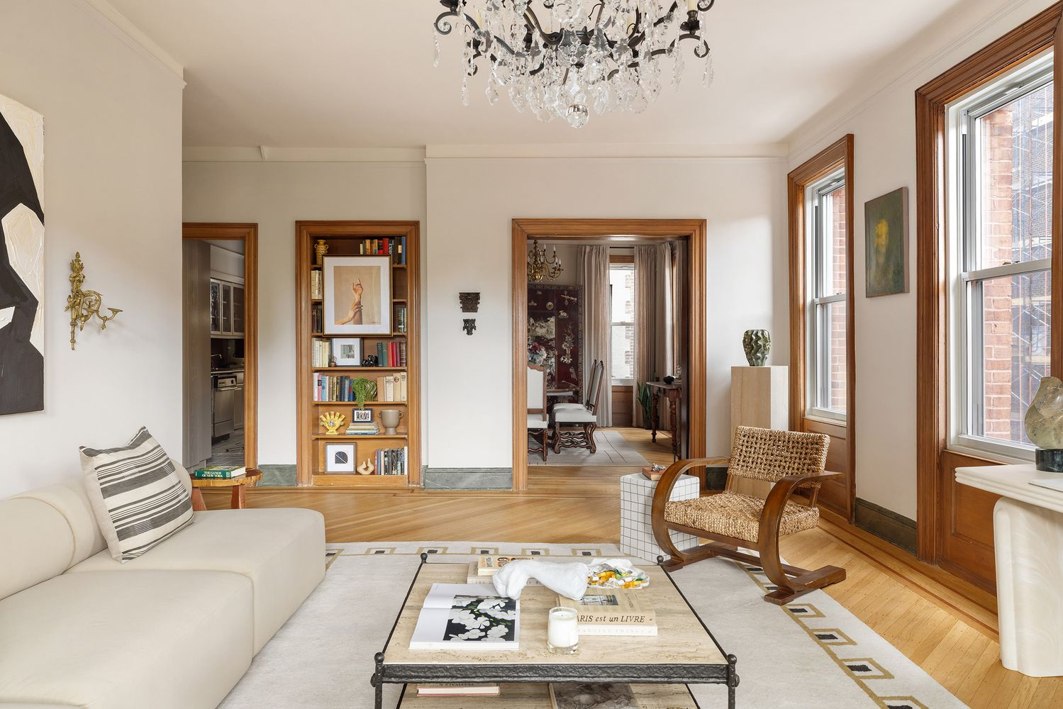 living room with wood floor and view into dining room and kitchen