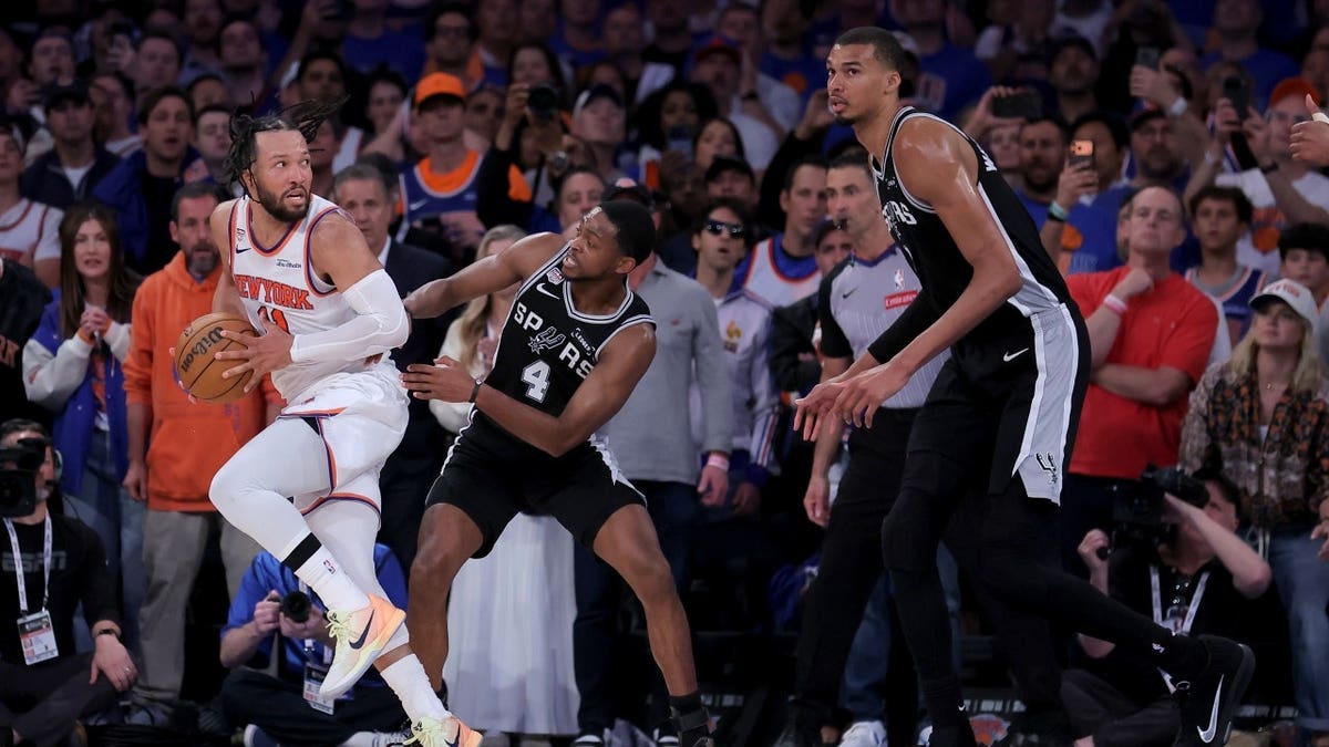New York Knicks PG Jalen Brunson is getting doubled by San Antonio Spurs PG De'aaron Fox and C Victor Wembanyama in Game 4 of the 2026 NBA Finals at Madison Square Garden.