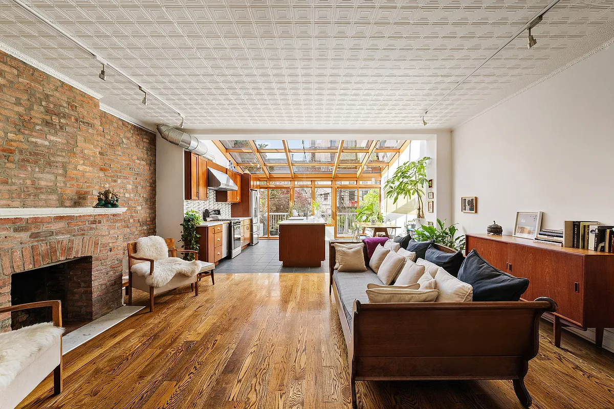 open plan living room and kitchen with tin ceiling