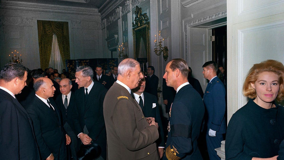 President Charles de Gaulle and Prince Philip standing together at the White House reception.