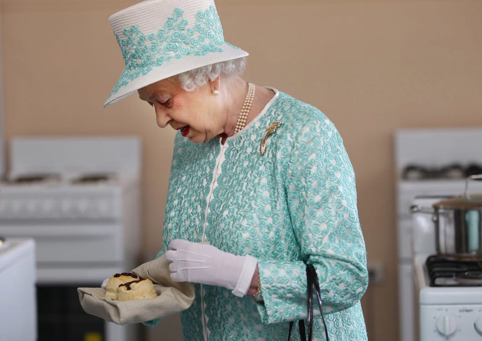 perth, australia october 27: queen elizabeth ii receives scones from the clontarf kitchen during her visit to clontarf aboriginal college on october 27, 2011 in perth, australia. the queen and duke of edinburgh are on a 10 day visit to australia and will travel to canberra, brisbane, and melbourne before heading to perth for the commonwealth heads of government meeting. this is the queens 16th official visit to australia. (photo by sharon smith pool/getty images)