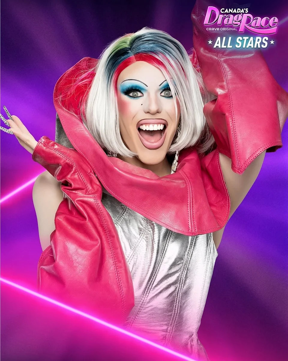 Person in a vibrant drag outfit with dramatic makeup and styled hair, smiling energetically in a promo for "Canada's Drag Race: All Stars."