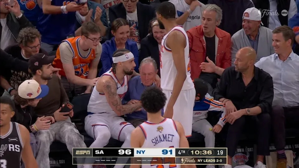 Knicks guard Jose Alvarado tends to former NYC Mayor Mike Bloomberg after flying into the stands Tuesday night. ABC