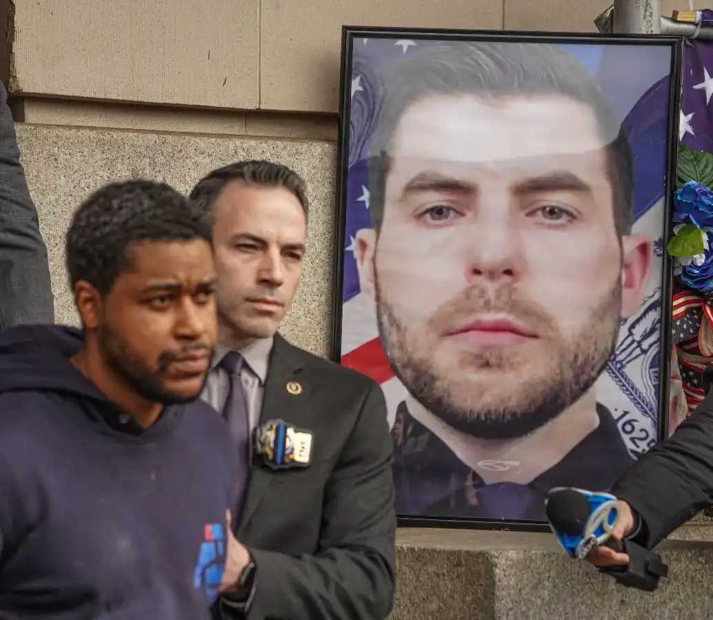 When Jones was escorted out of the 101st Precinct oin Far Rockaway after his arrest, detectives perp-walked him past a portrait of the fallen officer, who was posthumously promoted to detective. 