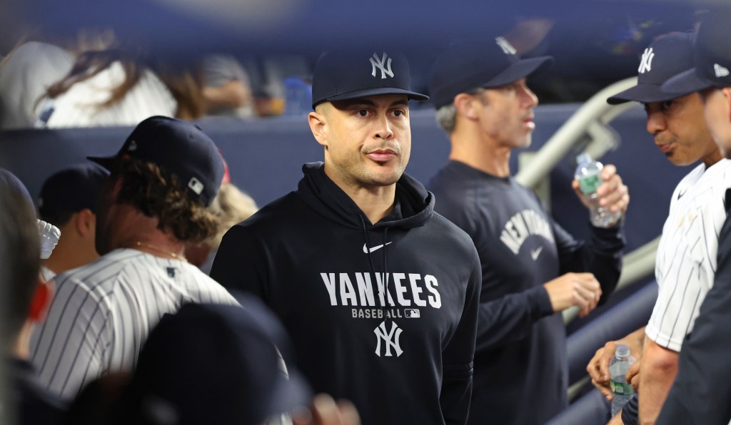 Giancarlo Stanton of the New York Yankees in the dugout.