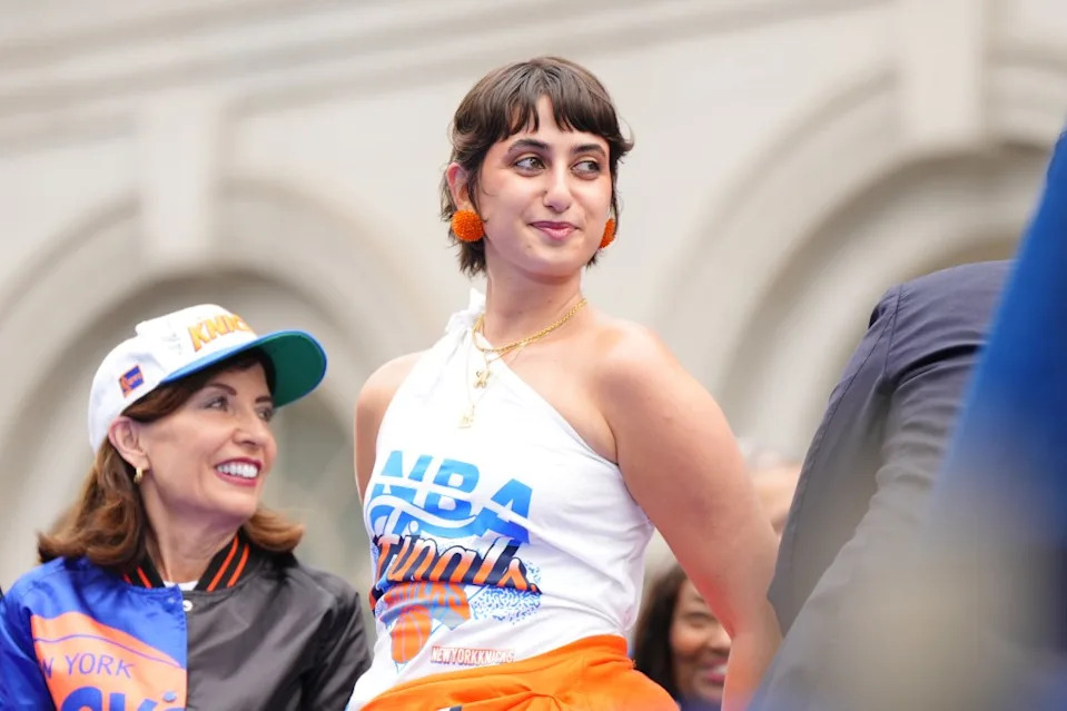 Gold necklaces and fluffy orange puff ball earrings finished off the parade look. Getty Images