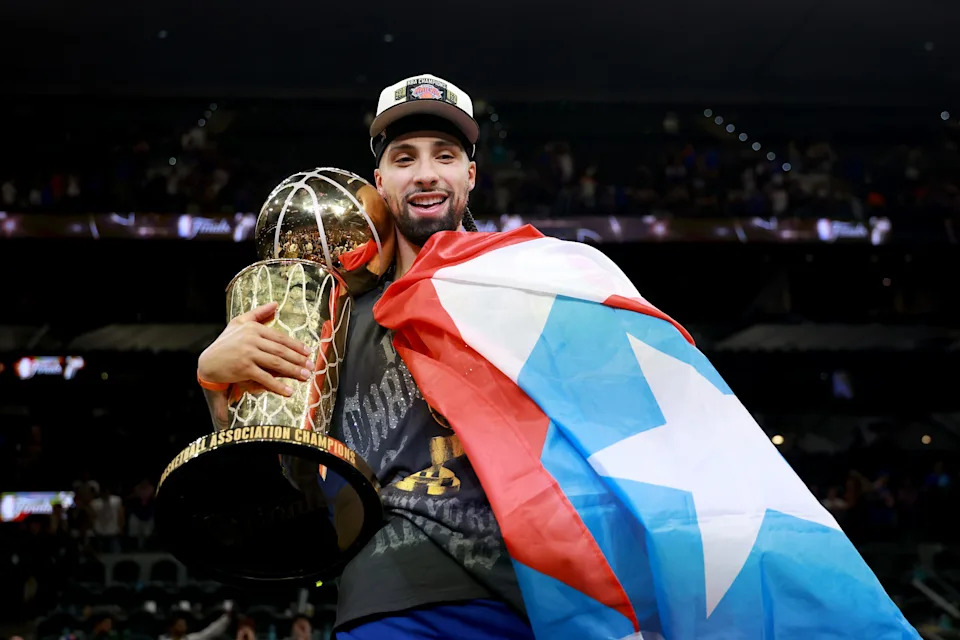 Jose Alvarado #5 of the New York Knicks celebrates with the Larry O'Brien Championship Trophy.