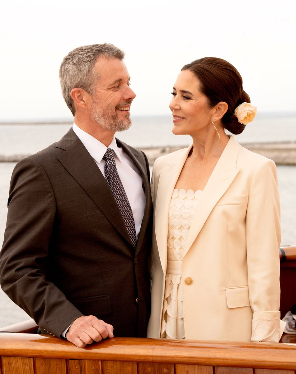 Queen Mary embraced timeless elegance aboard the Royal Yacht Dannebrog, styling her sleek low bun with a delicate cream rose for a romantic royal beauty moment.