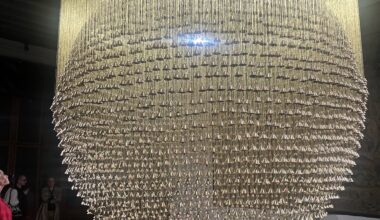 Ashfika Rahman, Than Para — No Land Without Us, 2025– . Installation with 4,849 temple bells (brass) bearing collected thumbprints from the community, golden silk threads, and metal frame. Courtesy the artist, in collaboration with the community of Than Para and the Chittagong Hill Tracts, Bangladesh. Photo: Monika Fabjinska.
