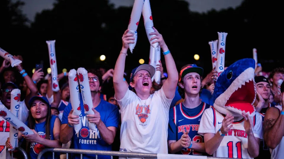 New York Knicks fans react during a watch party at the Wollman Rink in Central Park for Game 4. - Adam Gray/Getty Images North America/Getty Images