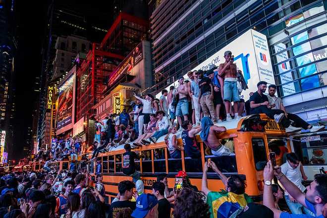 Knicks Fans Gather In NYC To Watch Game 5 Of The NBA Finals Against The San Antonio Spurs NEW YORK, NEW YORK - JUNE 14: New York Knicks fans climb on buses as they celebrate after they win the NBA Finals in Times Square on June 14, 2026 in New York City. The New York Knicks lead the San Antonio Spurs 3-1 and could win the franchise's first NBA championship since 1973 if they win tonight.(Photo by Adam Gray/Getty Images)