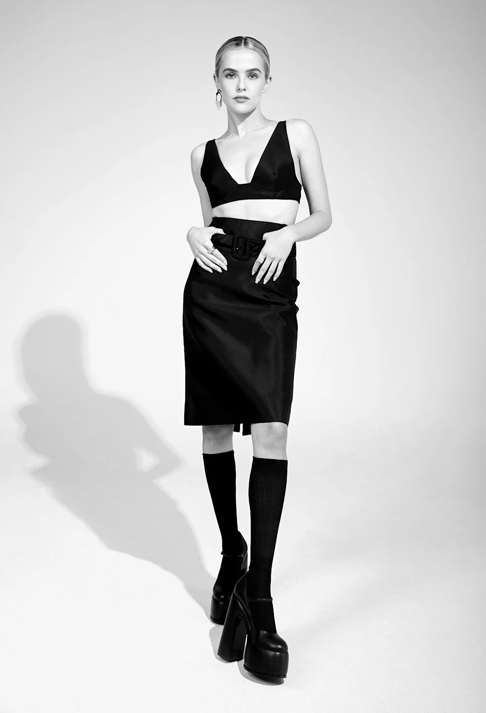 Prada’s silk top, silk skirt and socks. Casadei platforms; Nikos Koulis’ 18-karat gold earrings with white diamonds and black enamel; Demarson brass rings with pavé Swarovski crystals.