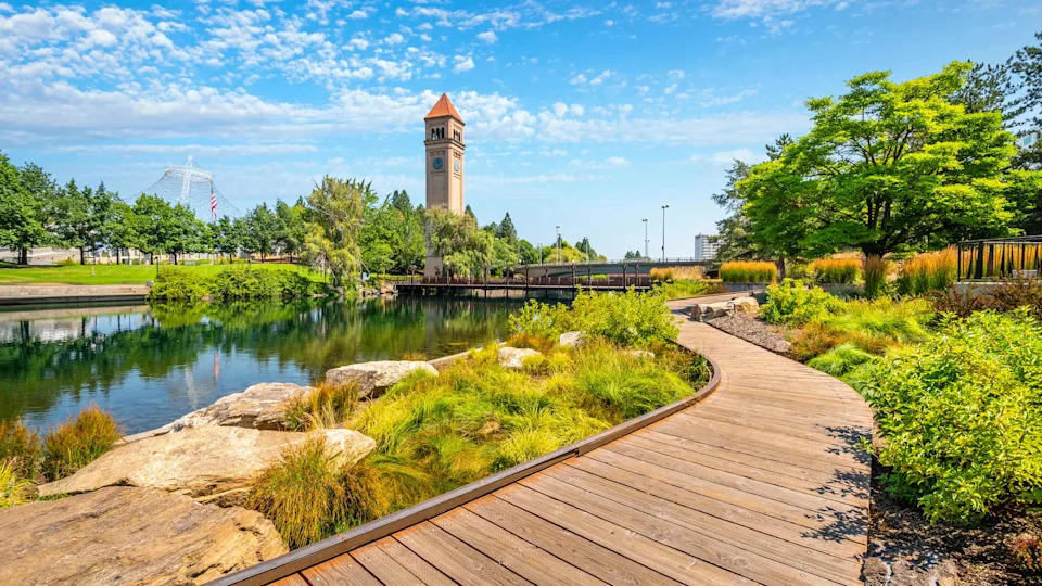 View from the Spokane River waterfront promenade path looking toward the expo pavilion and clock tower